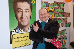 Besucher des TURKU Festivals vor Cem Özdemir-Plakat und Fotowand Aktionsfoto 1
